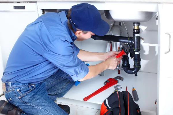 a male plumber fixing a toilet from Plumber Georgetown in Georgetown, TX a male plumber fixing a toilet from Plumber Georgetown in Georgetown, TX